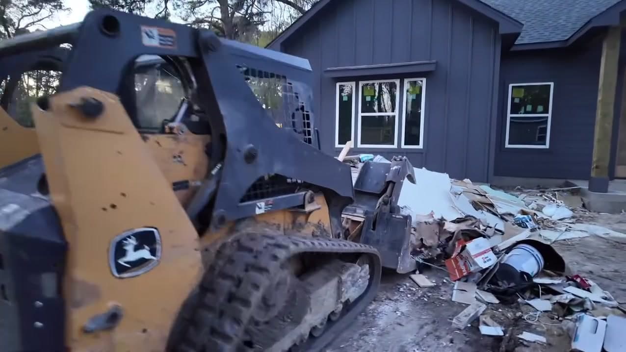 Bolt crew loading debris at a new build